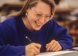 Photograph of a Graphic Design student at a drafting table