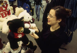 A photograph of a student browsing teddy bears in the Bookstore
