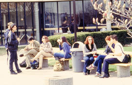 Photograph of students gathered on benches outdoors