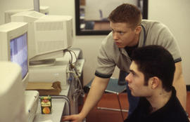 Photograph of students working with (CAD) drafting software