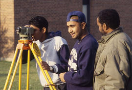 Photograph of Civil engineering students using survey equipment