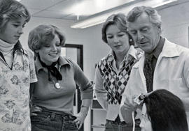 Photograph of Clint Hall Demonstrating How to Curl Hair on a Mannequin