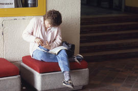 Photograph of a student sitting on a bench