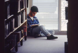 Photograph of a student studying in the library