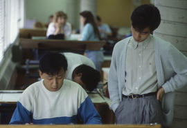 Photograph of students in conversation in a drafting lab