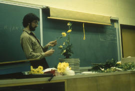 Photograph of a faculty member demonstrating floral arrangement in class