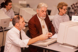 Photograph of Jim Hardy working with a student at a computer