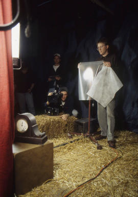 Photograph of Cinematography students using a variety of tools to photograph a clock