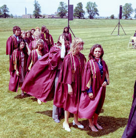 Photograph of graduates queuing up to go on stage to receive their diplomas