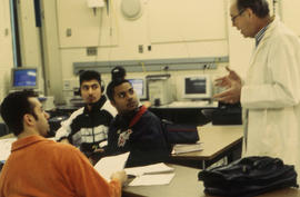 Photograph of Roy Fraser instructing a class of students