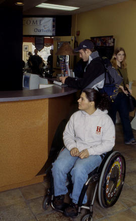 Photograph of a student in a wheel chair at the desk