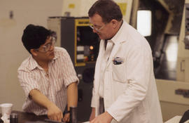 Photograph of an Instructor Talking to a Student