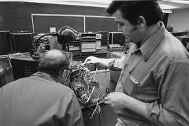 Photograph of Two Technicians Testing or Repairing Equipment
