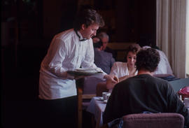 Photograph of Hotel and Restaurant student serving customers in the Humber Room