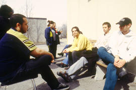A photograph of a group of students chatting outdoors
