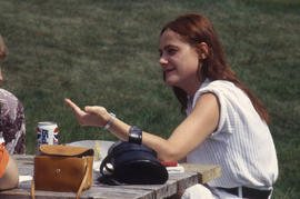 Photograph of a Student Talking on a Picnic Bench