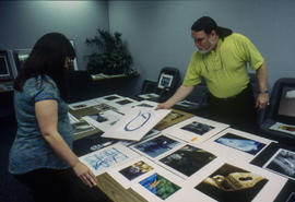 Photograph of faculty members reviewing students work