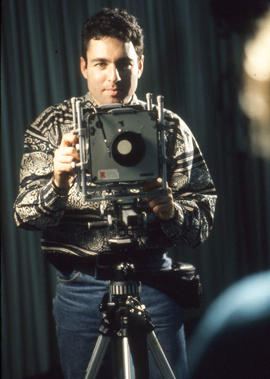 Photograph of a student Photographer behind the camera