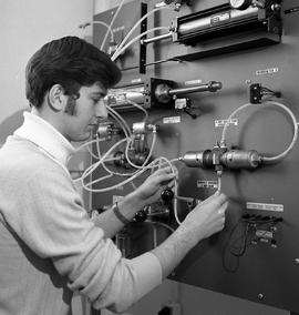 Photograph of an Electro Mechanical student completing an assignment on a pneumatic training bench