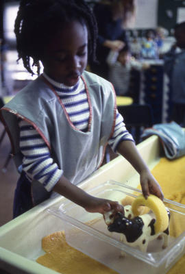 Photograph of a child washing a toy