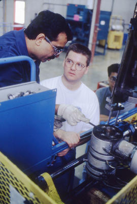 Photograph of a student adjusting an equipment