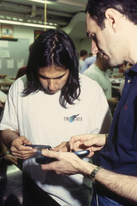 A photograph of Industrial Design students examining their peers' models