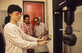 Photograph of an Instructor Showing Students a Machine