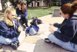 Photograph of students sitting on the walkway