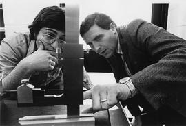 Photograph of Bob Shechter Using a Measurement Tool With a Student in the Industrial Lab