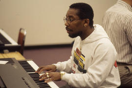 Photograph of a Music Student Practicing on an Electronic Keyboard