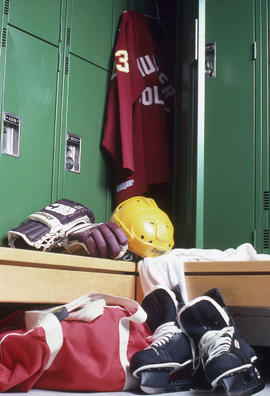 Photograph of hockey equipment by a locker in the Athletic Centre