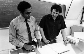Photograph of Saty Satyamurti Looking at Notes with a Student