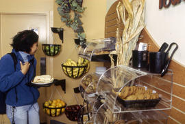 Photograph of student examining the fruits and pastries