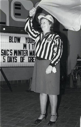 Photograph of Doris Tallon Waving a Flag During the Winter Maddness Event