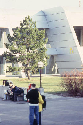 Photograph of students seated outside the N building