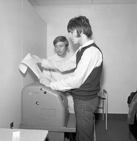 Photograph of a student checking news from the wire service in the Humber radio station