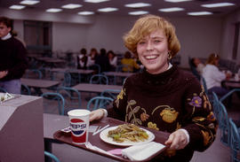 Photograph of a student in the cafeteria with a meal