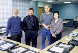 Photograph of four people in the Community Room