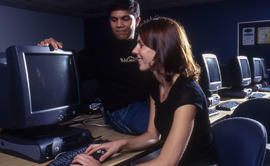 Photograph of students seated by the computer