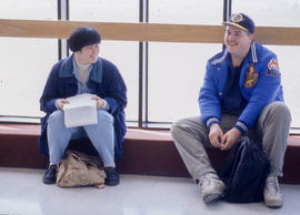 Photograph of students sitting in the hallway
