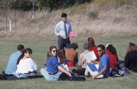 Photograph of an instructor lecturing outside