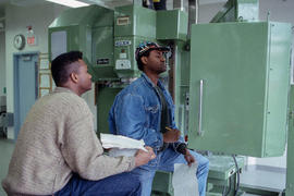 Photograph of students taking readings from a vertical machining tool