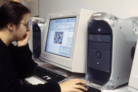Photograph of student seated in-front of a computer