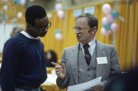 Photograph of unknown persons having a discussion