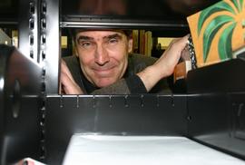 MP Michael Ignatieff looks through book shelves at opening of the Lakeshore Library : [photograph]