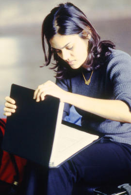 Photograph of a student checking her timetable.