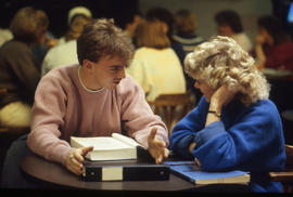 Photograph of students in discussion at a table in CAPS