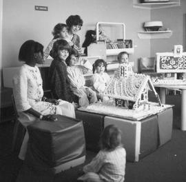 Photograph of Children in the Pediatric Ward Admiring a Gingerbread House