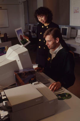 Photograph of Betty Tam-Cheung and a technician at the computer