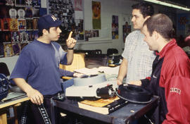 A photograph of three Industrial Design students in class together